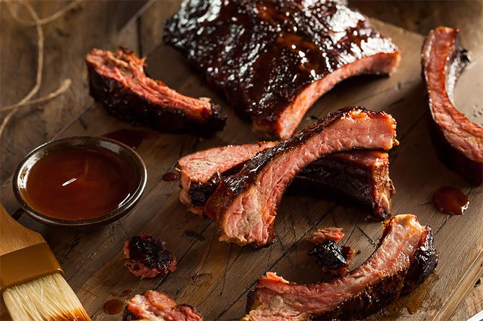 BBQ Ribs on a platter with a dipping dish of Lumberjack BBQ Sauce